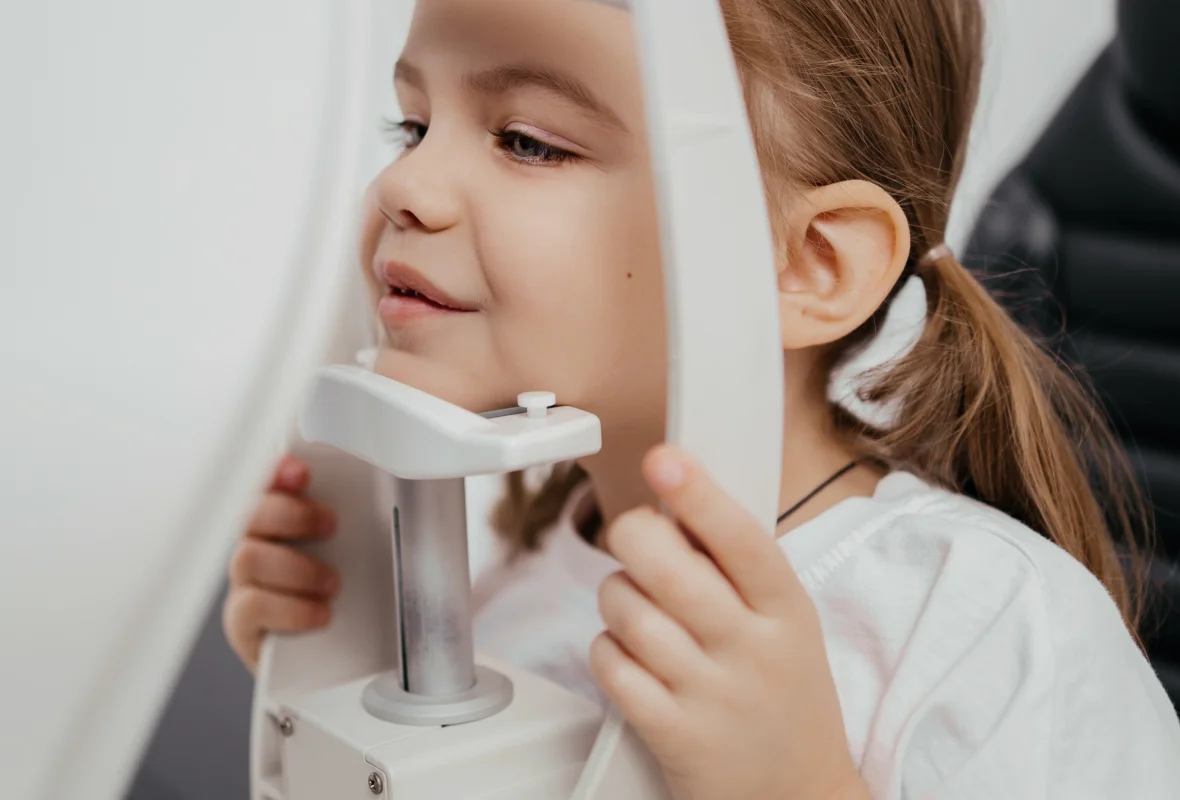 Young girl receiving an eye exam in a modern eye clinic in Calma, Algeria for early diagnosis of eye conditions